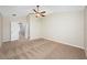 Spacious bedroom featuring neutral tones, carpet, and a ceiling fan at 2527 Silverback Ct, Palm Harbor, FL 34684