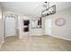 Spacious entryway with an archway to the kitchen with dark cabinets, tile floors and a stylish light fixture at 2527 Silverback Ct, Palm Harbor, FL 34684