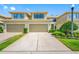 Two-story townhome boasts a two-car garage, well-maintained lawn and landscaping at 2527 Silverback Ct, Palm Harbor, FL 34684