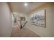 Carpeted hallway featuring a stairway and a striking art piece on the wall at 2527 Silverback Ct, Palm Harbor, FL 34684