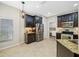 Well-equipped kitchen with stainless steel appliances, dark cabinetry, and granite countertops at 2527 Silverback Ct, Palm Harbor, FL 34684