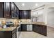 Open-concept kitchen with granite countertops, stainless steel appliances, and warm lighting at 2527 Silverback Ct, Palm Harbor, FL 34684