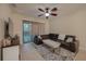 Comfortable living room with a leather sectional and ceiling fan at 2527 Silverback Ct, Palm Harbor, FL 34684