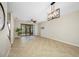 Spacious living room features tile floors, modern light fixture, and sliding glass doors at 2527 Silverback Ct, Palm Harbor, FL 34684