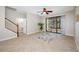 A welcoming living room with tile floors, an area rug, a ceiling fan, and sliding glass doors to the outdoor patio at 2527 Silverback Ct, Palm Harbor, FL 34684