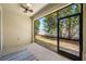 The screened-in patio offers an inviting view of the backyard, featuring tile flooring and a ceiling fan at 2527 Silverback Ct, Palm Harbor, FL 34684