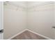 A compact walk-in closet featuring carpet flooring and wire shelving at 2527 Silverback Ct, Palm Harbor, FL 34684