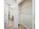Well-organized walk-in closet with shelving and easy access to bathroom at 2527 Silverback Ct, Palm Harbor, FL 34684