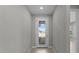 View of the front door from the foyer showing tile flooring and neutral wall colors at 2528 Charter Oak Dr, North Port, FL 34289