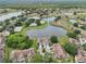 Community aerial shot displaying landscaping, bodies of water, and well-kept homes at 2602 Novack Ct, Sun City Center, FL 33573