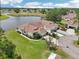 Aerial view of property featuring beautiful landscaping, circular drive and pond at 2602 Novack Ct, Sun City Center, FL 33573