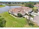 Beautiful aerial view of the waterfront home featuring a meticulously landscaped lawn and serene water views at 2602 Novack Ct, Sun City Center, FL 33573