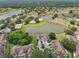 Beautiful aerial view showcasing lakeside homes, mature trees, and winding pathways at 2602 Novack Ct, Sun City Center, FL 33573