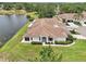 Scenic aerial view of a home with a serene lake view, showcasing the lovely landscaping and natural surroundings at 2602 Novack Ct, Sun City Center, FL 33573