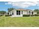 Inviting home exterior with a well-manicured lawn and a patio, perfect for outdoor enjoyment at 2602 Novack Ct, Sun City Center, FL 33573