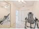 Bedroom featuring tile floor, a ceiling fan, mirrored closet doors, and inversion table at 2602 Novack Ct, Sun City Center, FL 33573