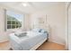 Comfortable bedroom features light-blue bedding, a large window, and wood-style floors at 2602 Novack Ct, Sun City Center, FL 33573