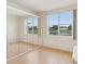 Bright bedroom with hardwood floors, a large window, and mirrored closet overlooking the lake at 2602 Novack Ct, Sun City Center, FL 33573