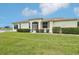 Well-maintained home exterior with lush green lawn and manicured shrubbery offering serene views at 2602 Novack Ct, Sun City Center, FL 33573