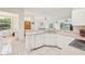Bright, well-lit kitchen with an open layout, white cabinetry, and modern appliances at 2602 Novack Ct, Sun City Center, FL 33573