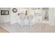Clean white kitchen with modern appliances, a breakfast bar, and tile flooring at 2602 Novack Ct, Sun City Center, FL 33573