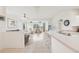Bright open-plan living room features ceiling fans, hard wood flooring, and lots of natural light at 2602 Novack Ct, Sun City Center, FL 33573