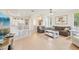 Spacious living room with wood floors, two sofas, and an open layout to the kitchen at 2602 Novack Ct, Sun City Center, FL 33573