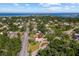 An aerial view of a home near the coast, marked by a red pin, nestled among lush greenery and waterways at 300 22Nd S Ave, St Petersburg, FL 33705