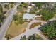 High angle view of a home with a unique roof design, surrounded by lush landscaping and mature trees at 300 22Nd S Ave, St Petersburg, FL 33705