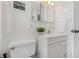 All-white bathroom featuring a toilet, a vanity, and a medicine cabinet at 300 22Nd S Ave, St Petersburg, FL 33705