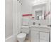 Cozy bathroom featuring a tub-shower combo, white tile, and a single sink vanity with storage at 300 22Nd S Ave, St Petersburg, FL 33705
