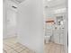 Bright bathroom showcasing a toilet, sink vanity with storage, mirror, and tiled floor at 300 22Nd S Ave, St Petersburg, FL 33705