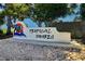 Tropical Shores community sign with palm tree art and beach stones at the base at 300 22Nd S Ave, St Petersburg, FL 33705