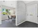 Stylish dining area next to an entryway featuring a glass block wall for natural lighting and privacy at 300 22Nd S Ave, St Petersburg, FL 33705