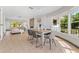 Sunlit dining area connected to living room with stylish table, chairs, and bright view of the front yard at 300 22Nd S Ave, St Petersburg, FL 33705