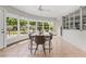 Bright dining room featuring a modern table set, ample natural light, and a view of the home's landscaping at 300 22Nd S Ave, St Petersburg, FL 33705