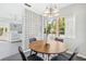 Cozy dining area featuring modern lighting, a round table, and a stylish glass block wall partition at 300 22Nd S Ave, St Petersburg, FL 33705