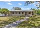 Inviting single-Gathering home with a lovely front yard and a welcoming pathway to the entrance at 300 22Nd S Ave, St Petersburg, FL 33705