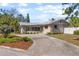 Attractive home boasting a unique roofline, mature landscaping, and a spacious driveway leading to the entrance at 300 22Nd S Ave, St Petersburg, FL 33705
