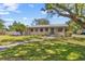 Charming single-story home featuring a well-manicured lawn, lovely landscaping, and a welcoming walkway at 300 22Nd S Ave, St Petersburg, FL 33705
