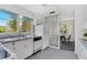 Well-lit kitchen with white appliances, a tile backsplash, and ample counter space for meal preparation at 300 22Nd S Ave, St Petersburg, FL 33705