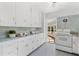 Bright kitchen featuring white cabinets, vintage details, and a functional layout for culinary creativity at 300 22Nd S Ave, St Petersburg, FL 33705
