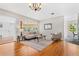Bright living room featuring hardwood floors, modern furniture, and large windows offering plenty of natural light at 300 22Nd S Ave, St Petersburg, FL 33705
