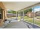 Enclosed back porch featuring a jacuzzi, screen windows, and a view of the backyard shed at 3176 Duane Ave, Oldsmar, FL 34677