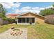 Backyard with a brick firepit and an enclosed screen patio for entertaining at 3176 Duane Ave, Oldsmar, FL 34677