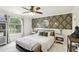 Bright bedroom featuring a patterned accent wall, window, and clean stylish decor at 3176 Duane Ave, Oldsmar, FL 34677