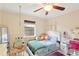 Charming bedroom with playful decor, a hanging chair, and soft natural light at 3176 Duane Ave, Oldsmar, FL 34677