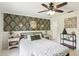 Comfortable bedroom with patterned accent wall, modern decor, and bright natural light at 3176 Duane Ave, Oldsmar, FL 34677