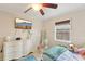 Cozy bedroom featuring a television, hanging chair, and a serene atmosphere at 3176 Duane Ave, Oldsmar, FL 34677