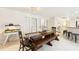 Dining room featuring a large wooden table, bench seating, and views into the kitchen at 3176 Duane Ave, Oldsmar, FL 34677